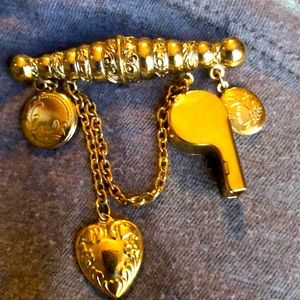 Vintage goldtone brooch with two locket charms, a heart and a whistle